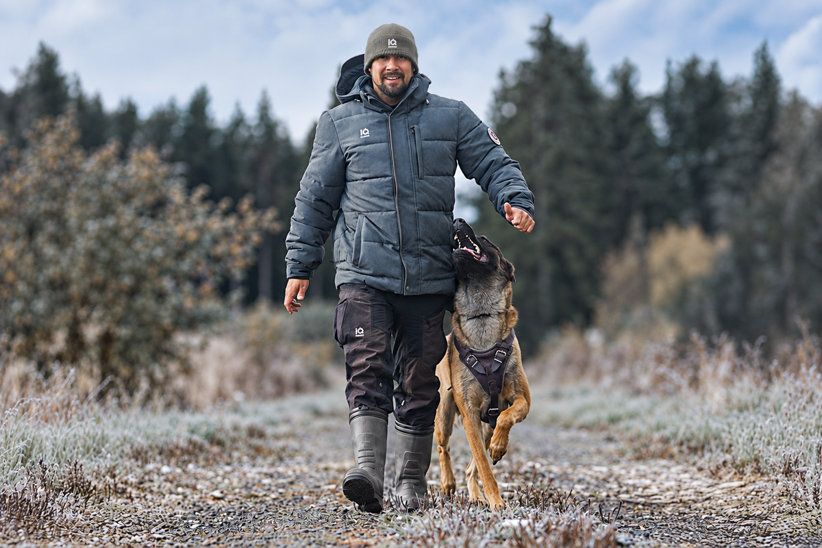 Tino wearing the IQ Winter Parka while training with his dog